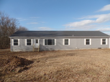 LOCATED ON 1.54 ACRES IS A BRAND NEW MANUFACTURED HOME.